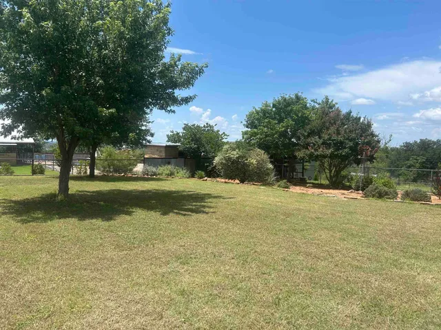a swimming pool with trees in the background