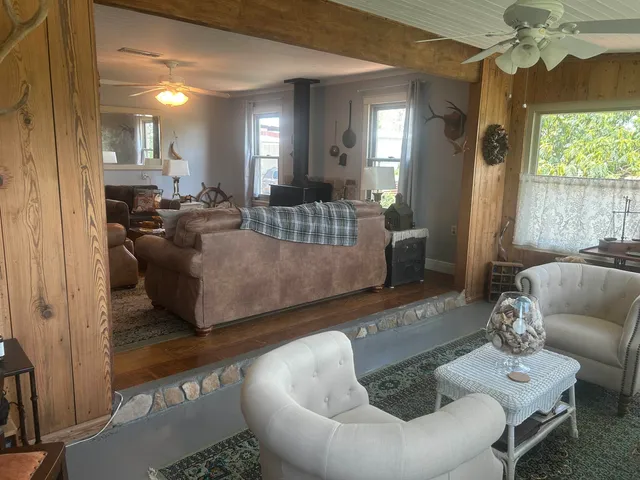 a living room with furniture and a chandelier