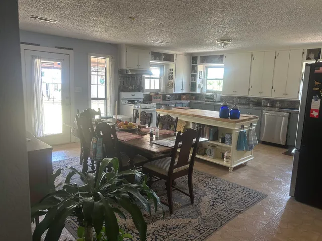 a view of a dining room with furniture and window
