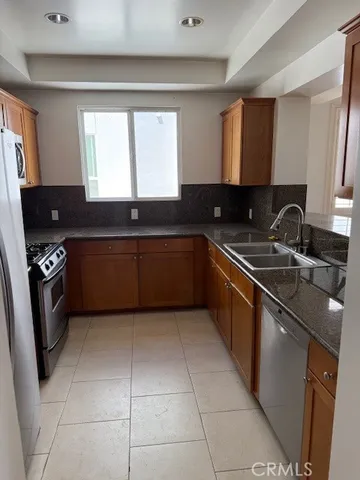 a kitchen with a sink a stove and cabinets