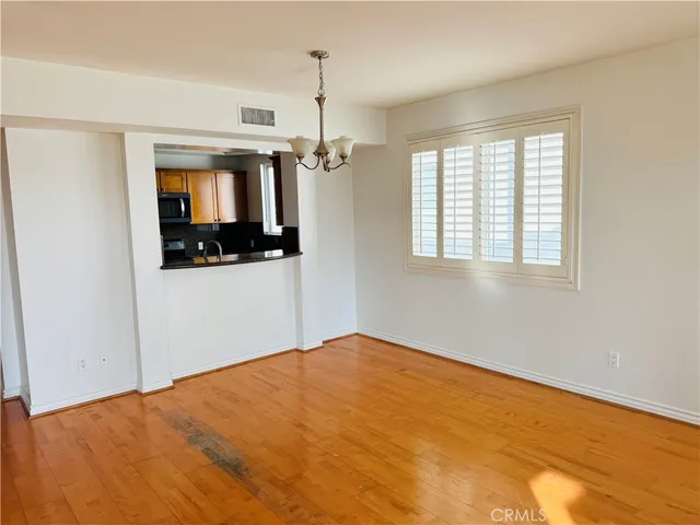a view of empty room with window and ceiling fan