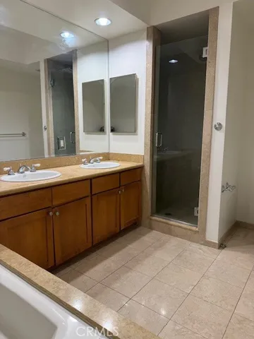 a bathroom with a double vanity sink and mirror
