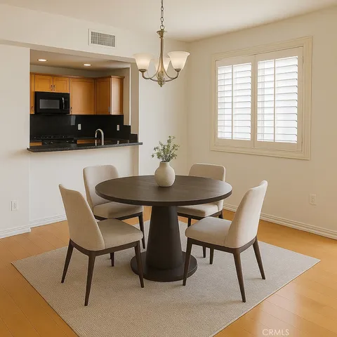 a view of a dining room with furniture and wooden floor