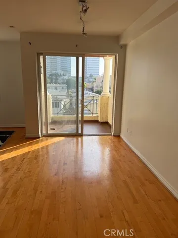 a view of a room with wooden floor and a window