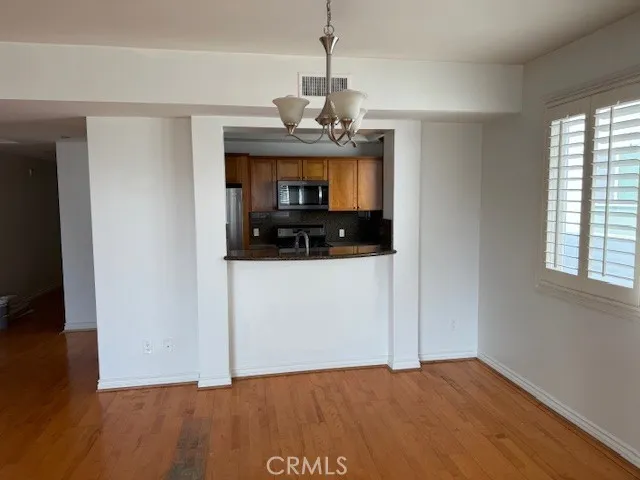 a view of a room with a sink and wooden floor