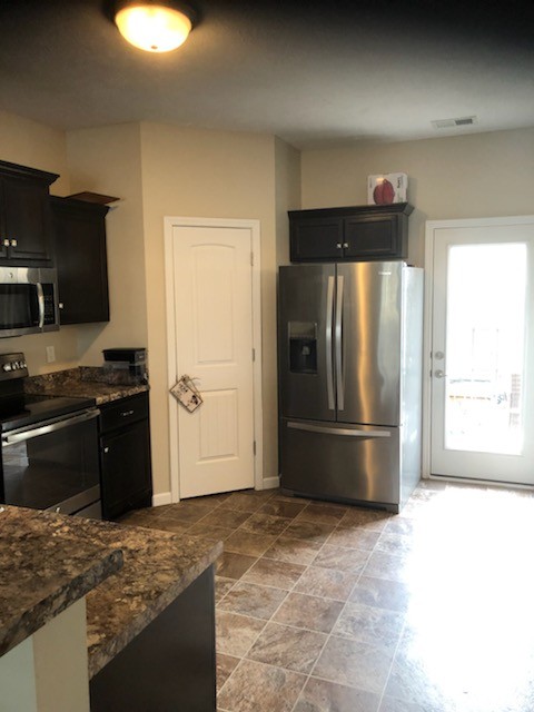 435 Kubota Drive Murfreesboro, TN 37128 - Photo 5 of 8 a kitchen with a refrigerator and a stove top oven