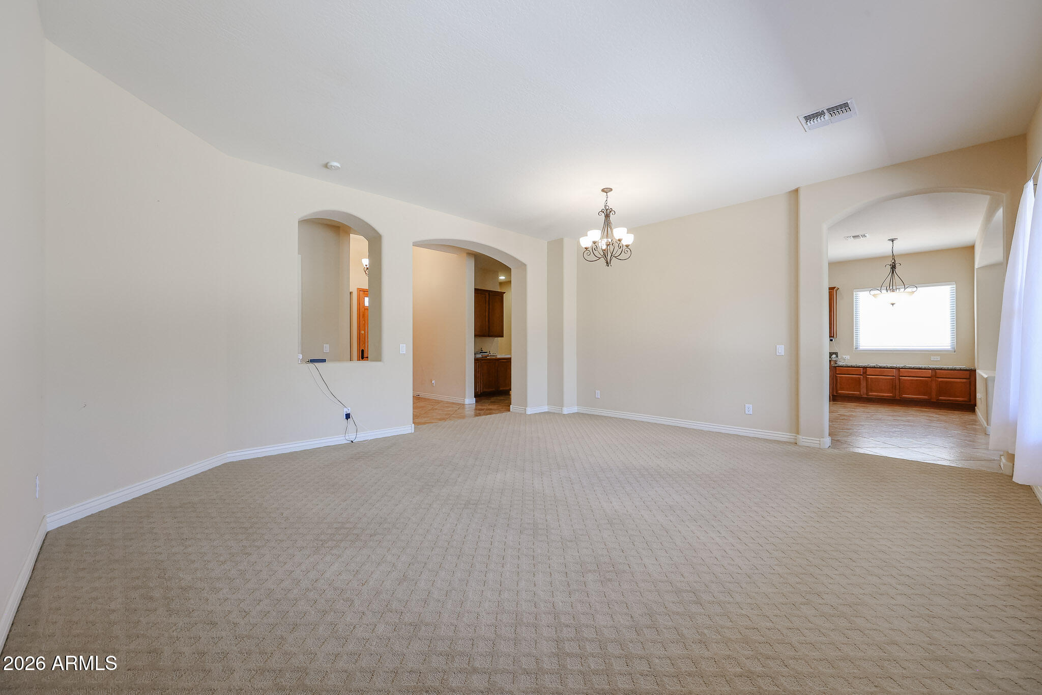 18175 West Narramore Road Goodyear, AZ 85338 - Photo 10 of 72 a view of a big room with closet and chandelier fan