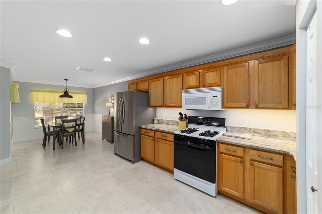 8125 South W 81st Loop Ocala, FL 34476 - Photo 23 of 58 a kitchen with stainless steel appliances granite countertop sink stove top oven and cabinets