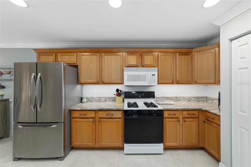 8125 South W 81st Loop Ocala, FL 34476 - Photo 25 of 58 a kitchen with a sink and a refrigerator