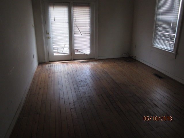 515 Ridge Street Charlottesville, VA 22902 - Photo 8 of 15 an empty room with wooden floor and windows