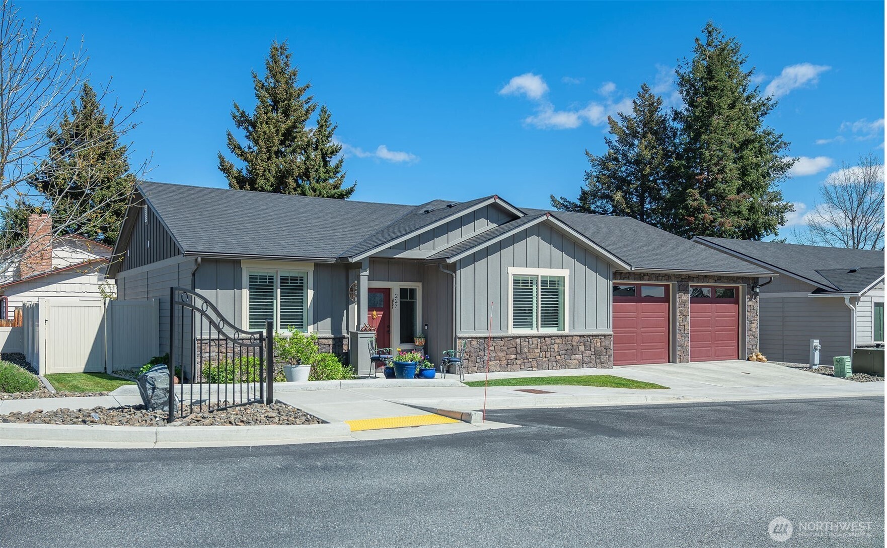 227 Pershing Circle Wenatchee, WA 98801 - Photo 1 of 38 a front view of a house with a yard and garage