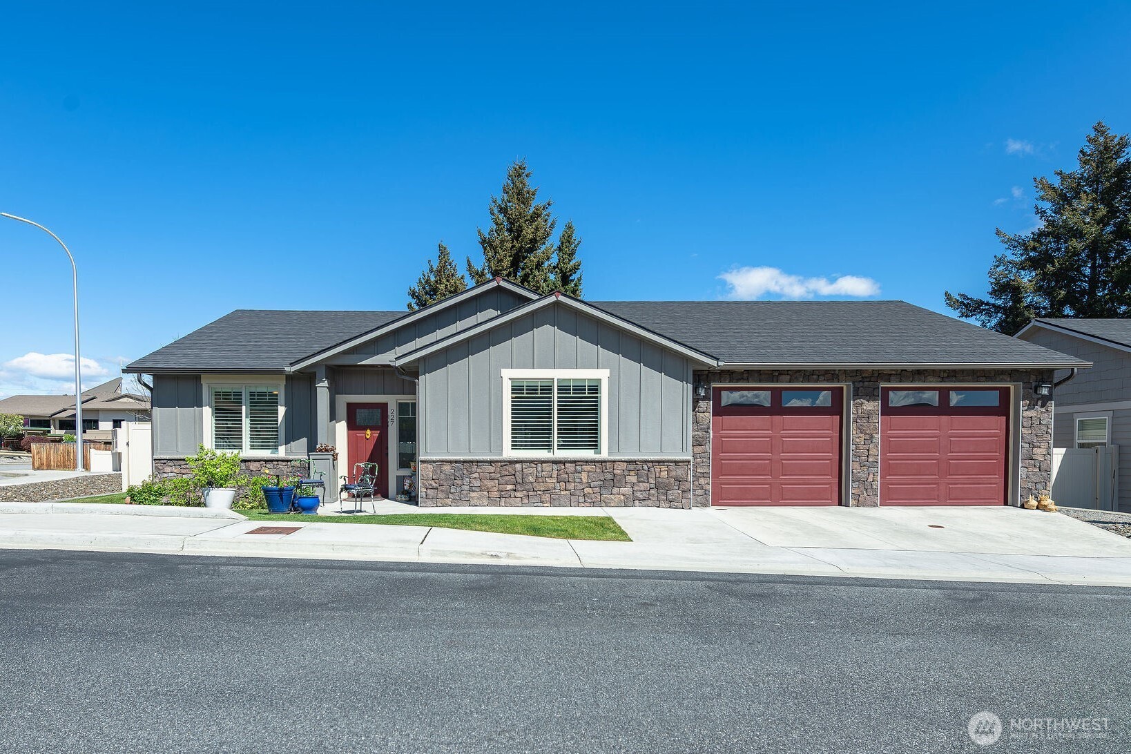 227 Pershing Circle Wenatchee, WA 98801 - Photo 2 of 38 a front view of a house with a yard and garage