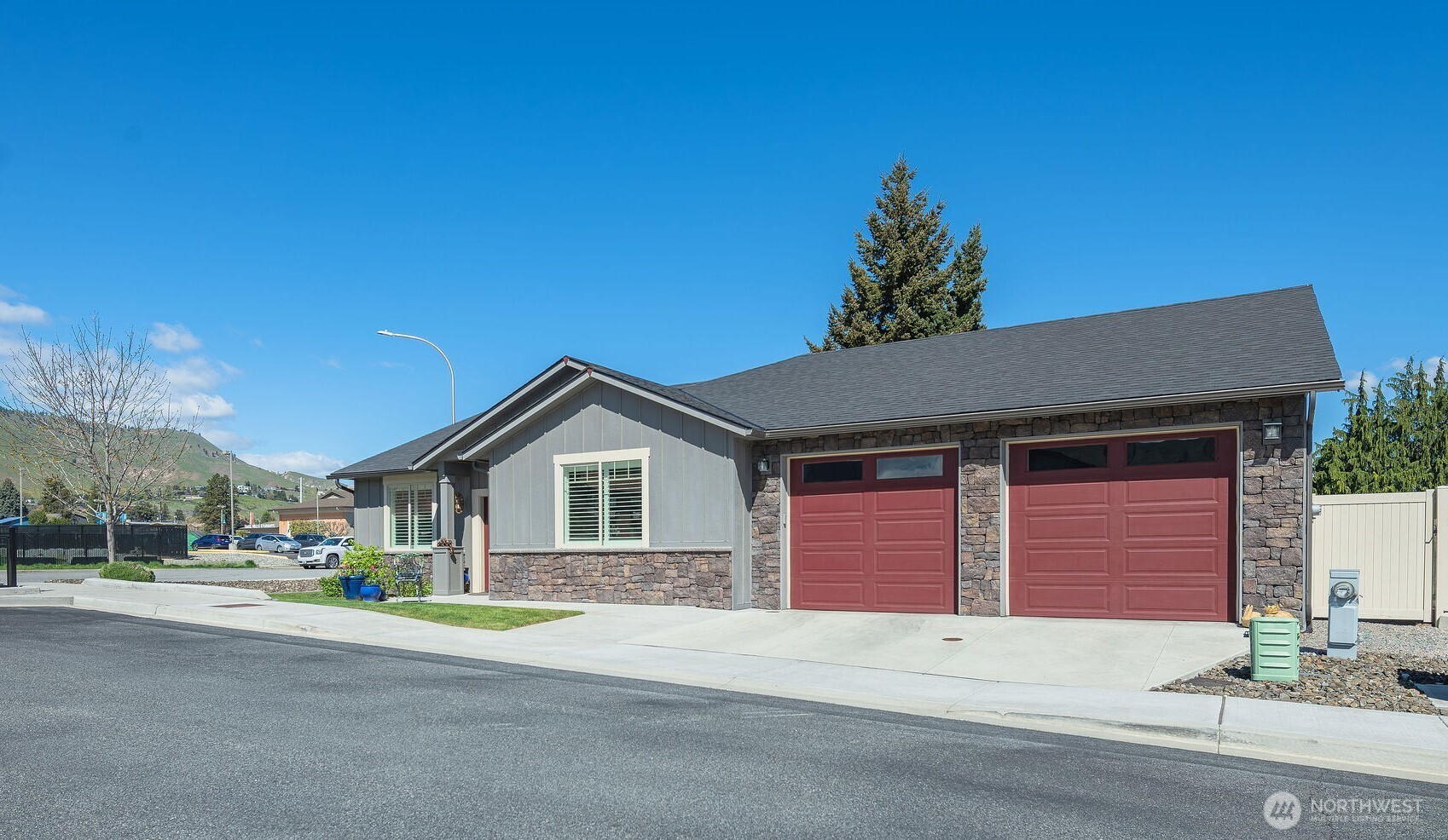 227 Pershing Circle Wenatchee, WA 98801 - Photo 3 of 38 a front view of a house with a yard and garage