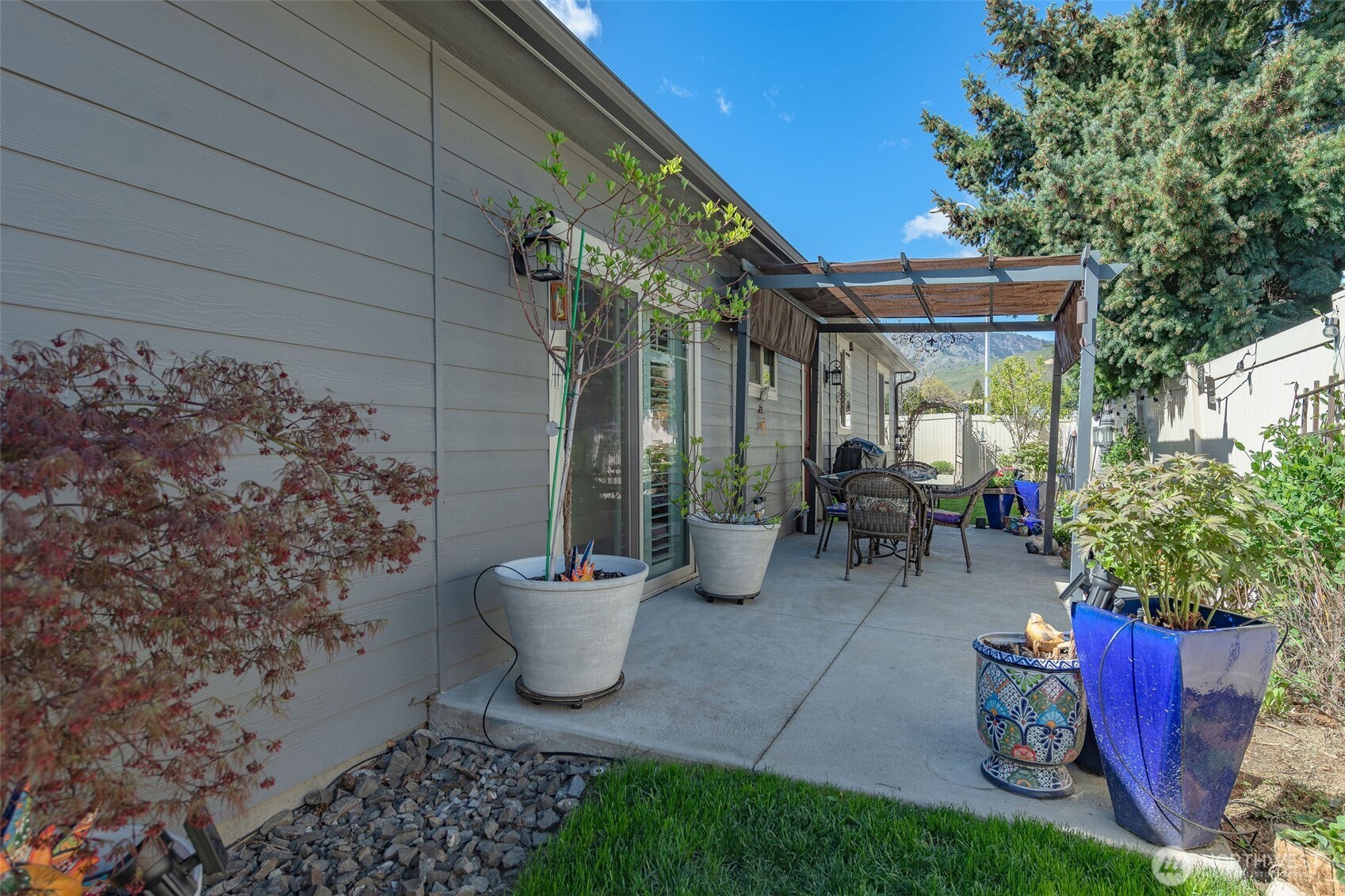 227 Pershing Circle Wenatchee, WA 98801 - Photo 34 of 38 a view of a chair and tables back yard of the house