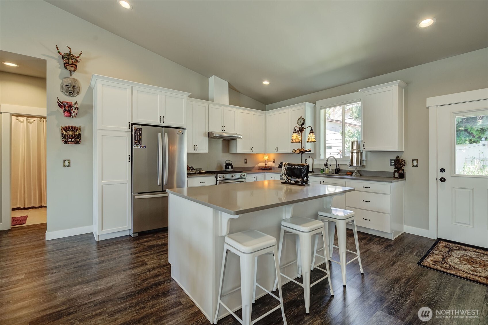 227 Pershing Circle Wenatchee, WA 98801 - Photo 10 of 38 a kitchen with white cabinets and stainless steel appliances