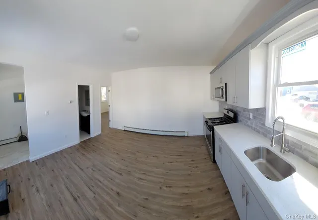 a kitchen with a sink and a large window