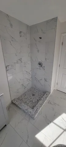 a view of a hardwood floor and a window in a room