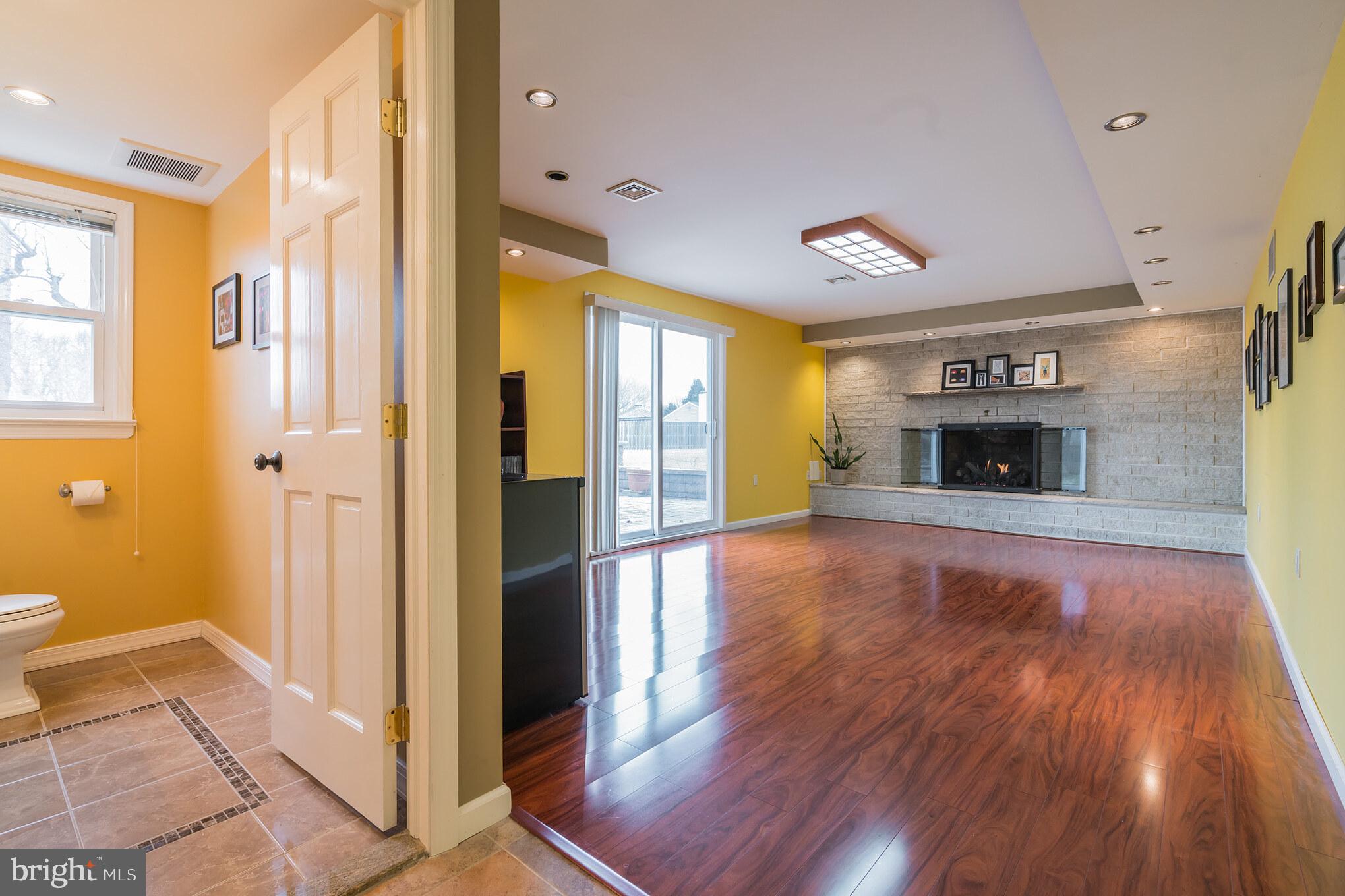 14 Azalea Way Hamilton, NJ 08690 - Photo 13 of 33 a view of a hallway with wooden floor and a fireplace