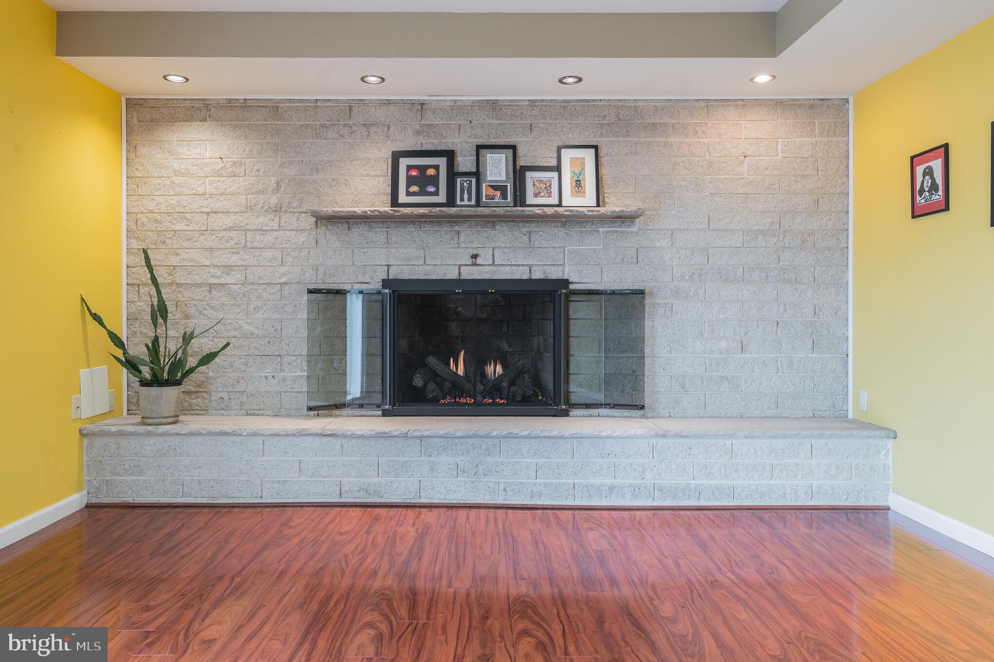 14 Azalea Way Hamilton, NJ 08690 - Photo 15 of 33 a living room with a fireplace and a wooden floor
