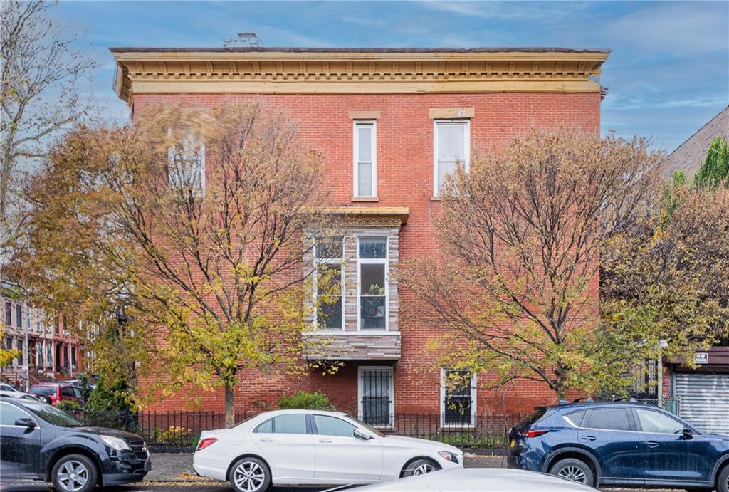 399 Monroe Street Brooklyn, NY 11221 - Photo 2 of 6 a front view of a building with parking space