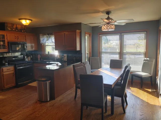 a bathroom with a granite countertop sink mirror vanity and a bathtub