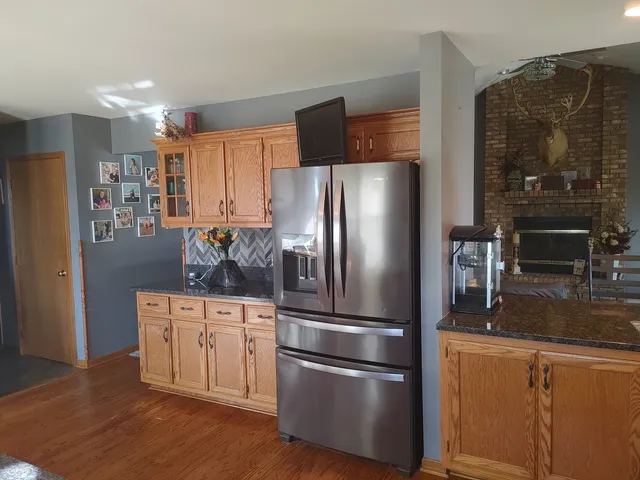 a view of a room with wooden floor and chandelier