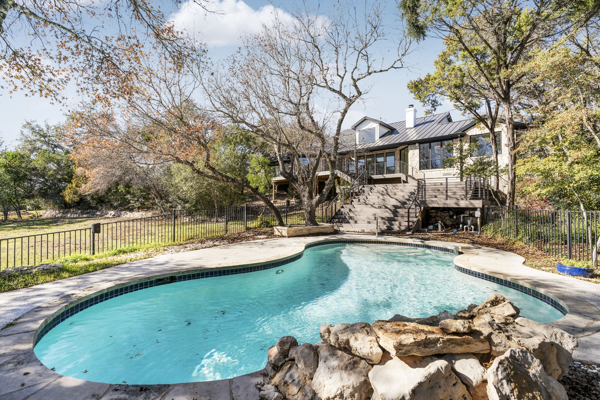 701 Furlong Drive Austin, TX 78746 - Photo 3 of 40 a view of a swimming pool with a patio and a yard
