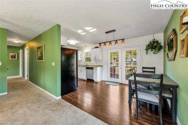 a view of a kitchen with furniture and wooden floor