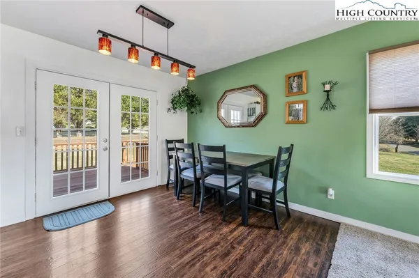 a dining room with a wooden table and a window