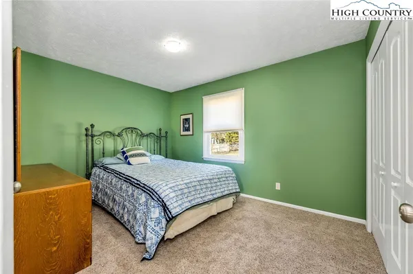 a bedroom with a bed and a table in it