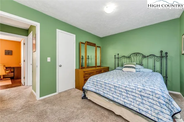 a bedroom with a bed and a mirror