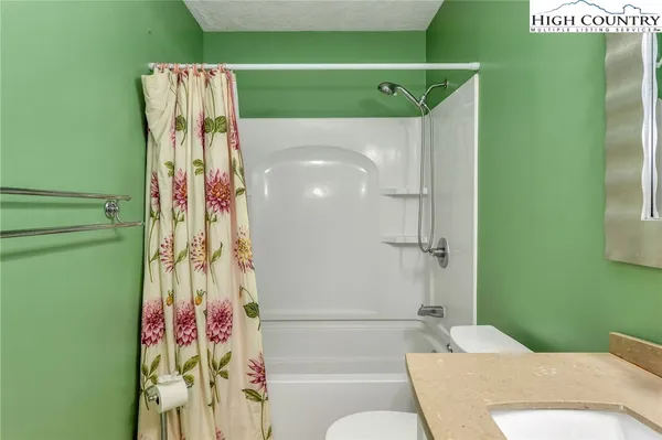 a bathroom with a shower and a sink