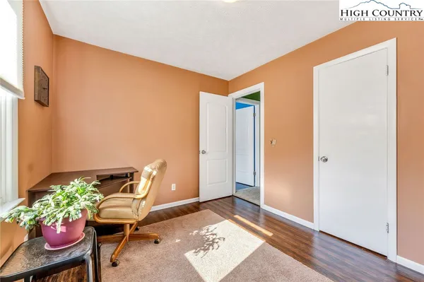 a view of workspace with furniture and wooden floor