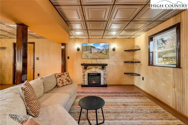 a living room with furniture a fireplace and a table