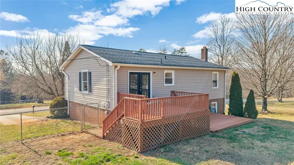 a view of a house with a yard and tree s