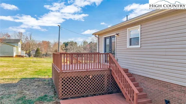 a view of a balcony with yard