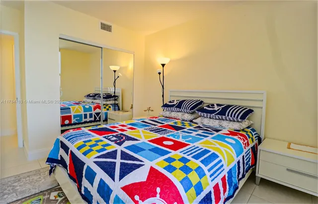 a spacious bedroom with a bed and window