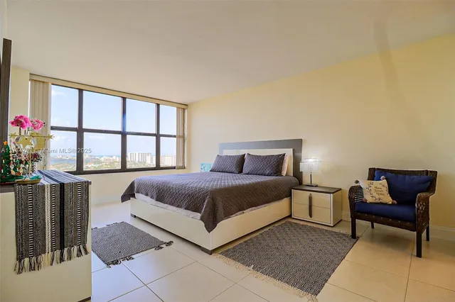 a spacious bedroom with a bed and window