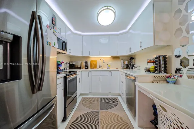 a kitchen with a refrigerator a sink and cabinets