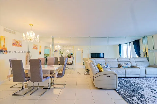 a living room filled with furniture and a chandelier