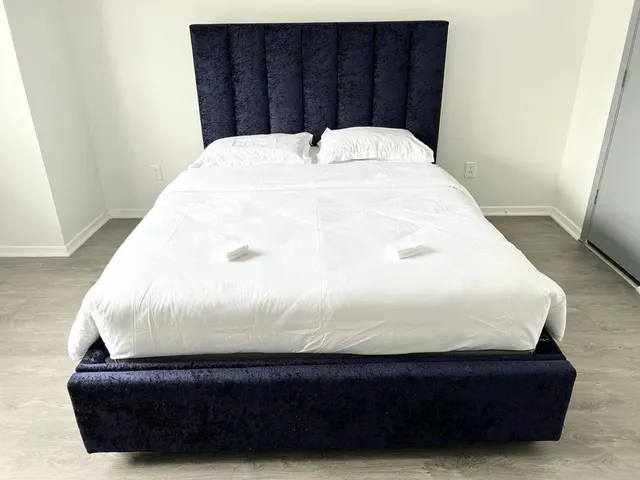 a bathroom with a bathtub and a wooden floor