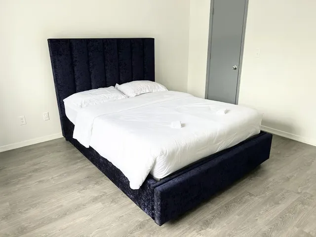 a large bed sitting in a bedroom with closet