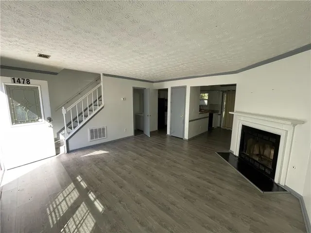 a view of a livingroom with an empty space and a fireplace
