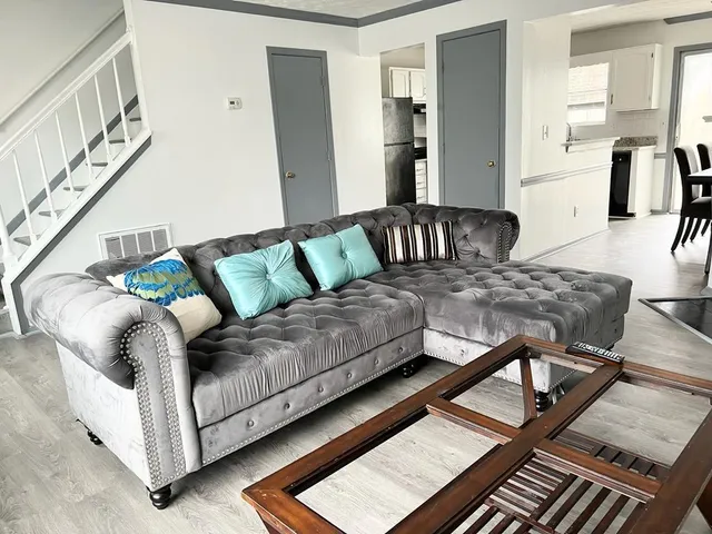 a living room with furniture and wooden floor