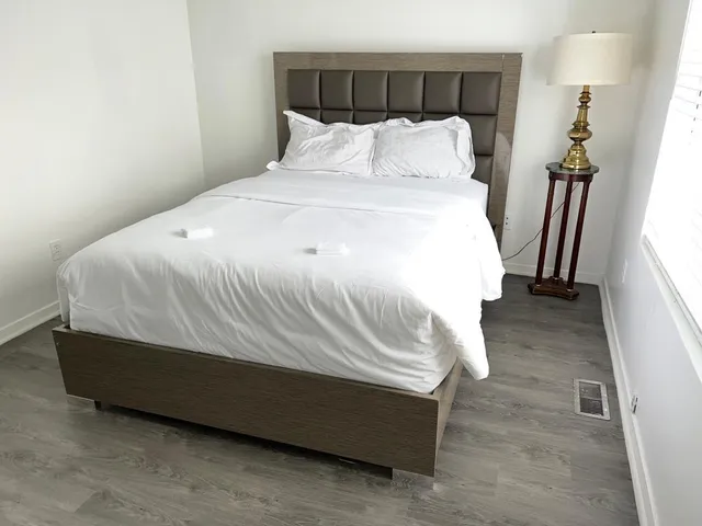 a bed sitting in a bedroom next to a window