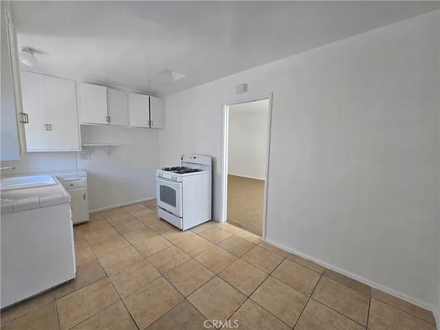a utility room with cabinets washer and dryer