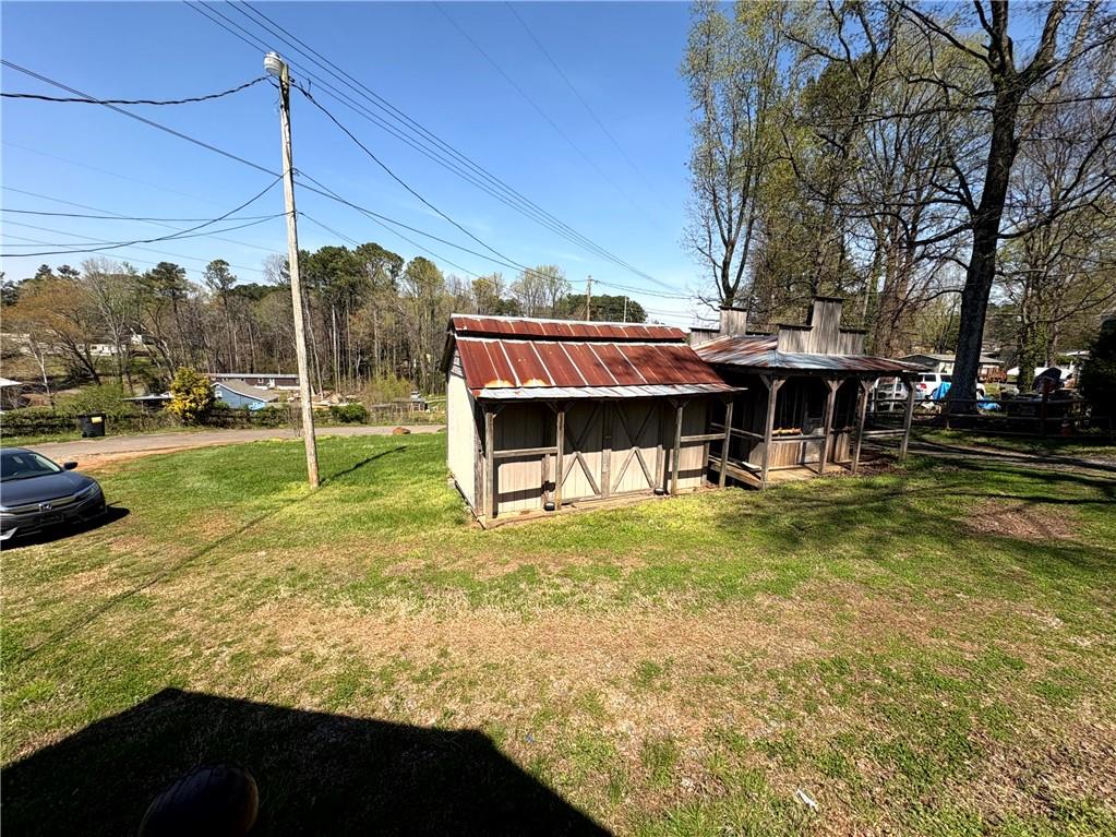 440 Cherry Street Southeast Acworth, GA 30102 - Photo 25 of 73 a view of a swimming pool with a table and chairs under an umbrella
