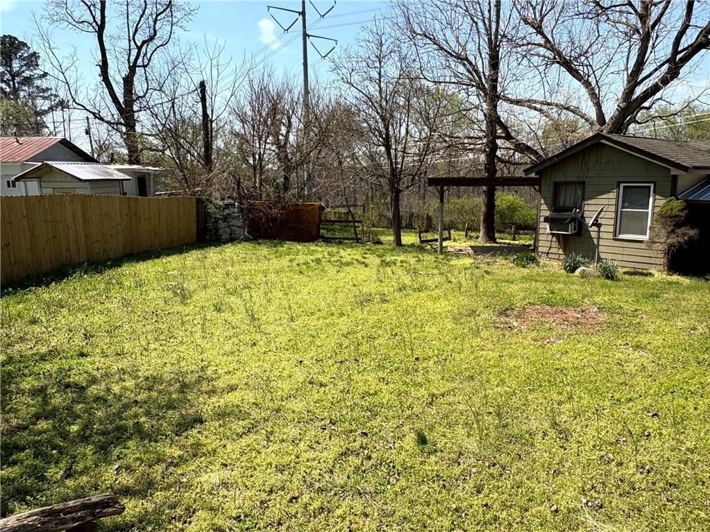 440 Cherry Street Southeast Acworth, GA 30102 - Photo 27 of 73 a backyard of a house with large trees and wooden fence