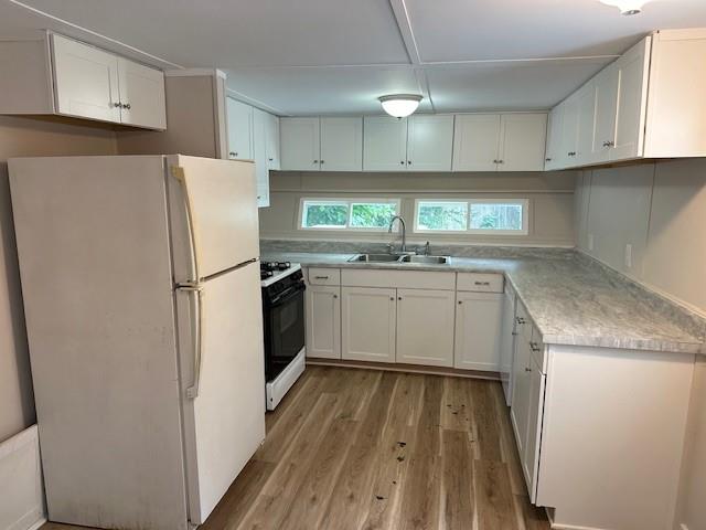 440 Cherry Street Southeast Acworth, GA 30102 - Photo 49 of 73 a kitchen with a sink a refrigerator and cabinets