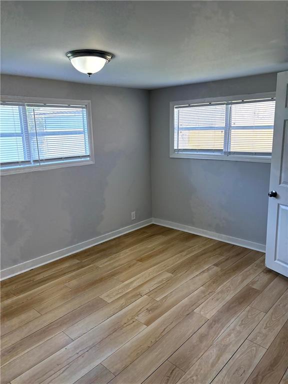 440 Cherry Street Southeast Acworth, GA 30102 - Photo 8 of 73 a view of an empty room with a window and wooden floor